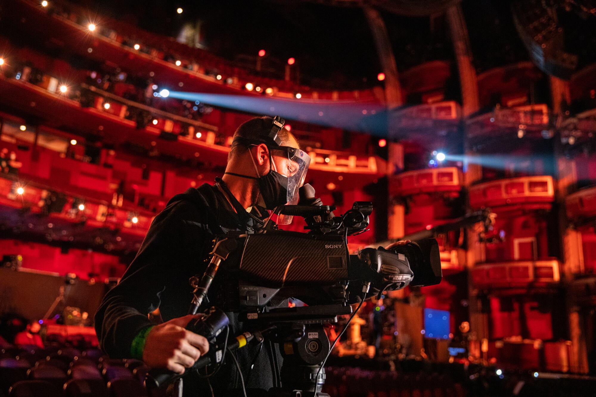 Camera operator Dylan Sanford in full PPE inside Dolby Theatre during rehearsals.
