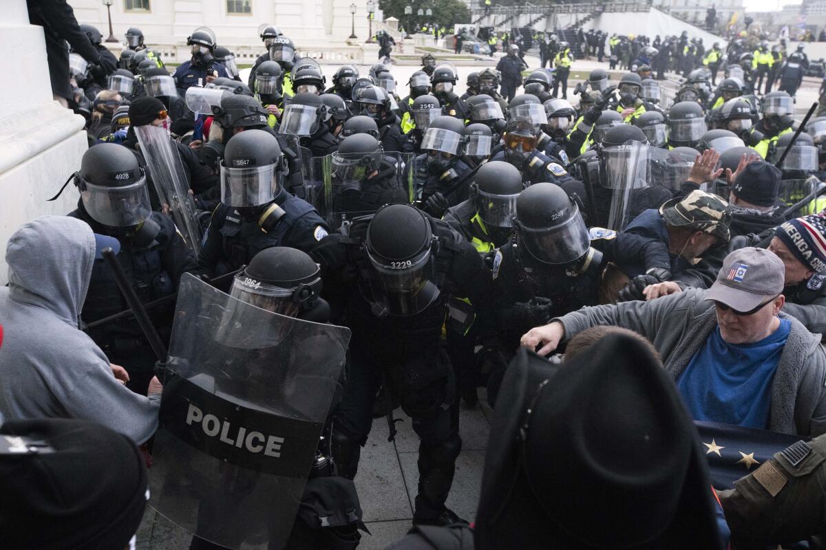 Police push back rioters trying to enter the Capitol