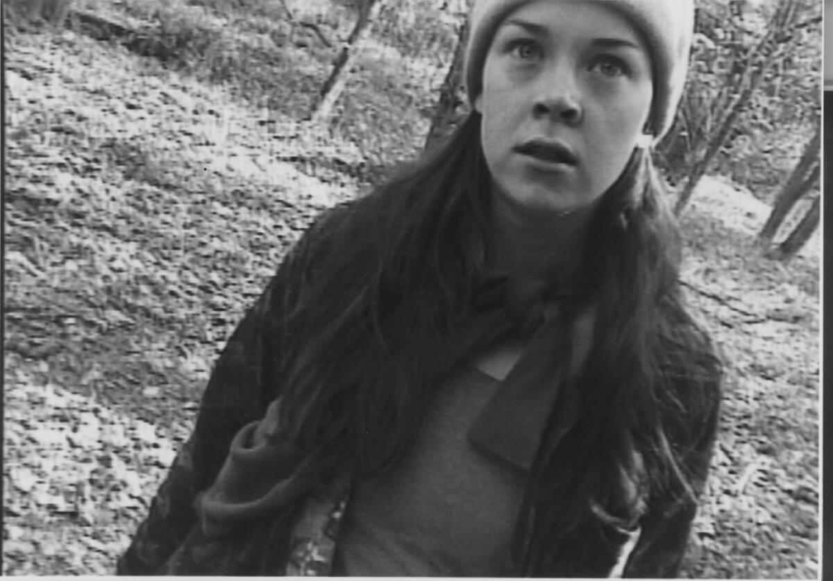 A black-and-white photo of a weary young woman