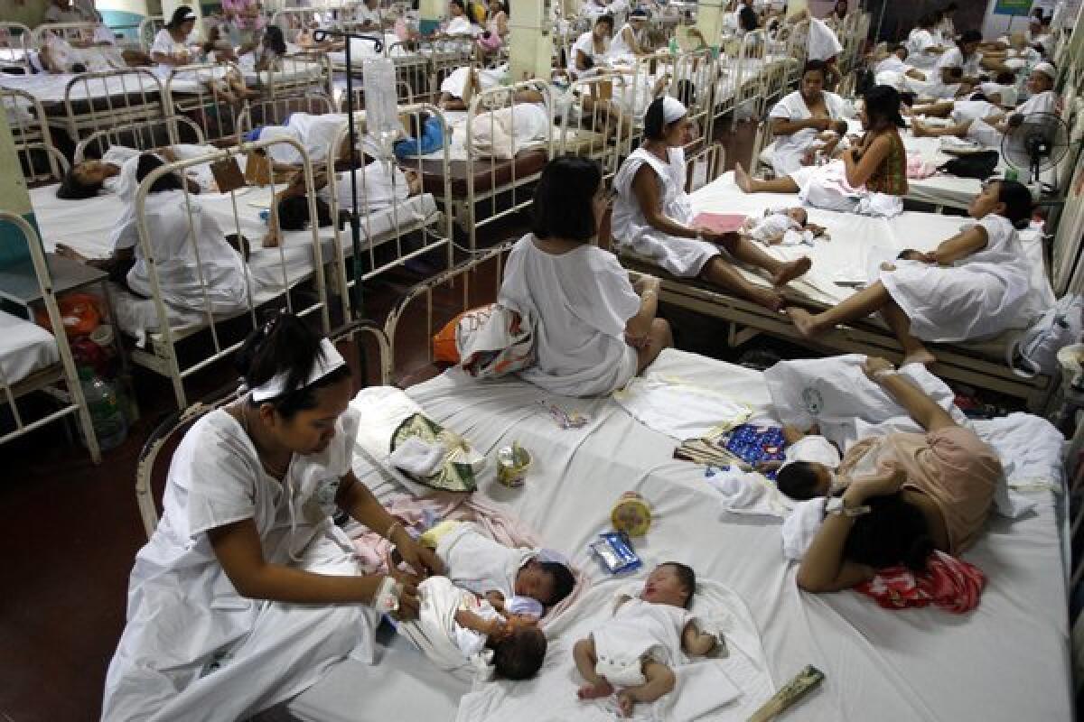 Even in the low season there are more than two women per bed in the recovery room of Dr. Jose Fabella Memorial Hospital in Manila, shown in this 2009 photo. The Philippines has the highest birthrates in Southeast Asia.