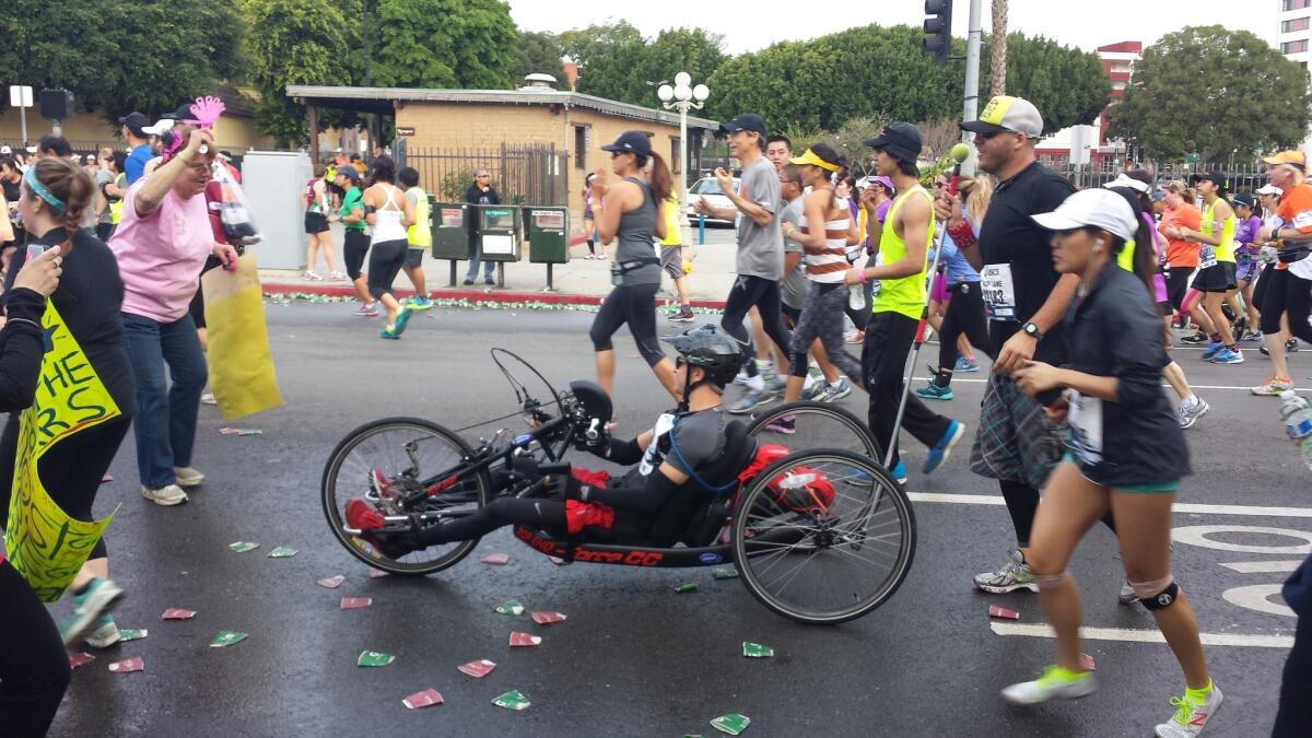 Runners and wheelchair racers make their way through downtown Los Angeles during the L.A. Marathon.