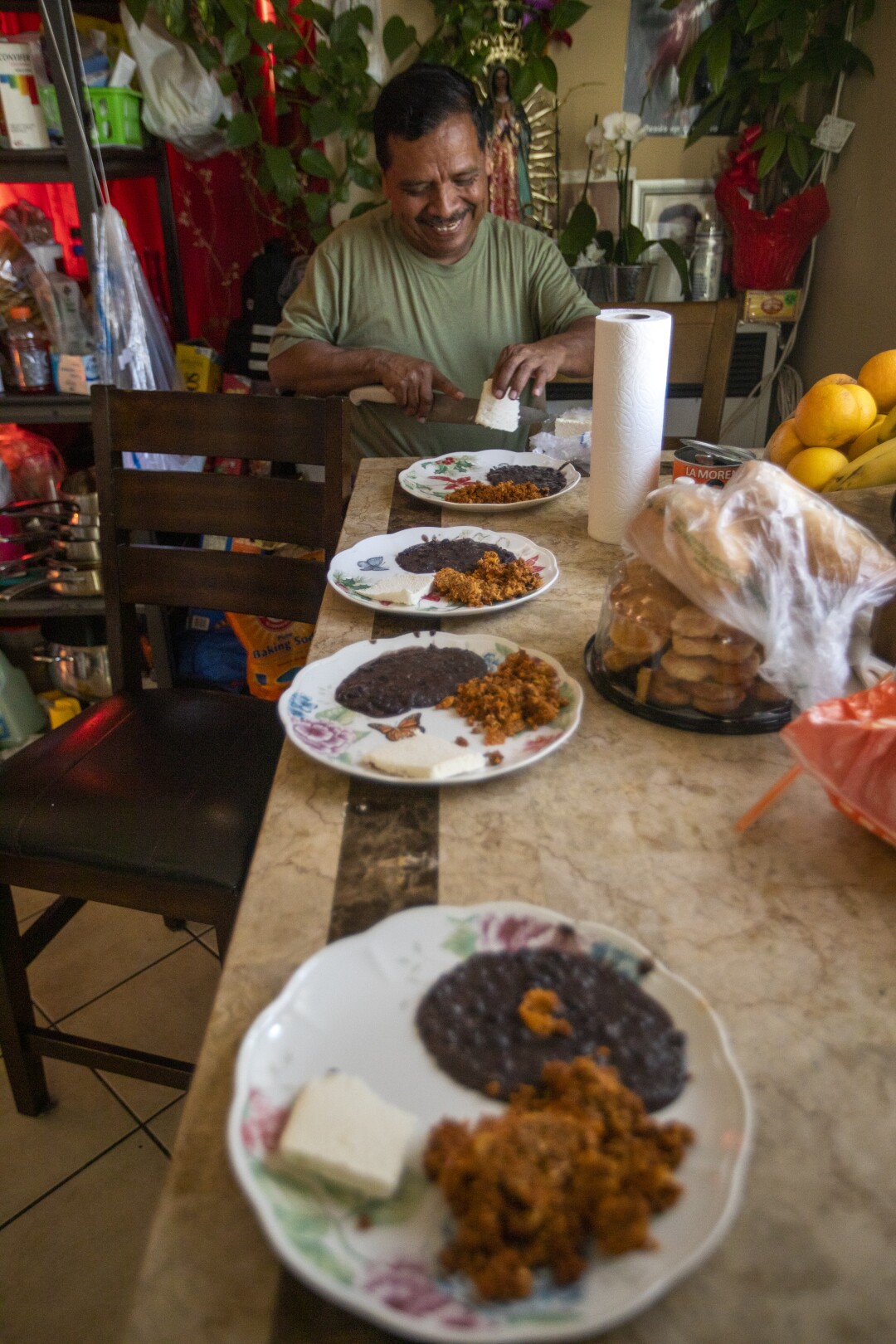 After working all day, Jose Morales comes home and prepares dinner.