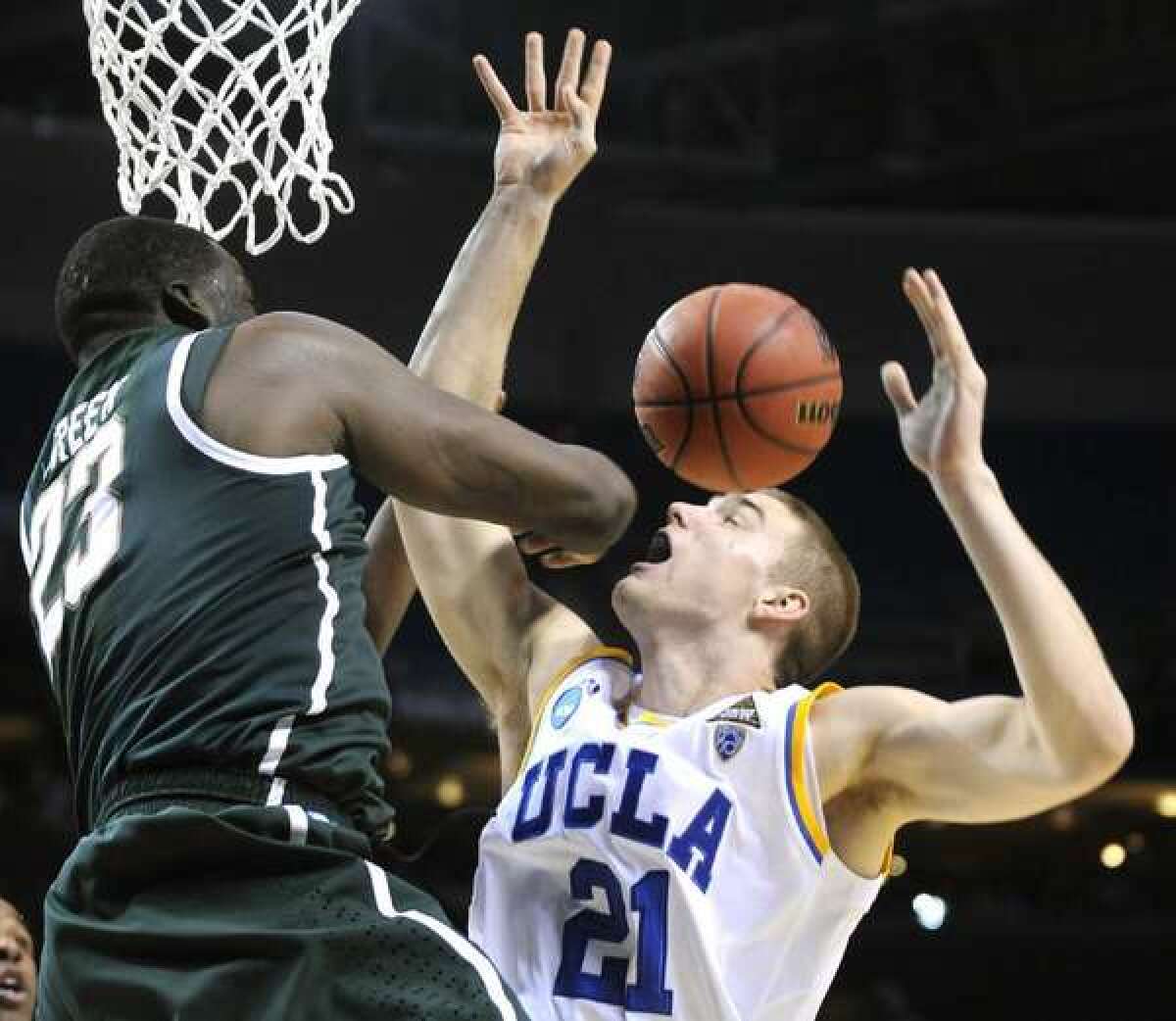 Brendan Lane is fouled by Michigan State's Draymond Green on March 17, 2011.