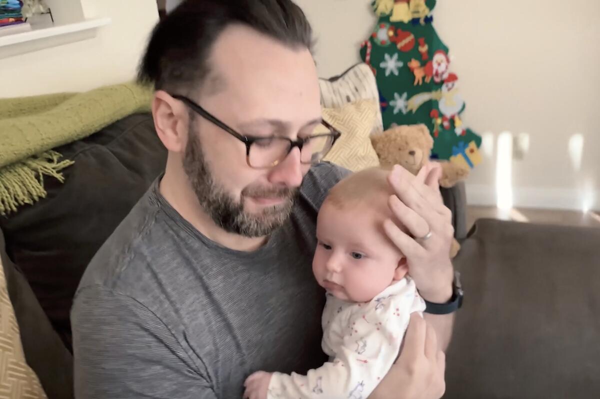 Video screenshot of Alexander Cardinale holding his biological daughter, Zoe.