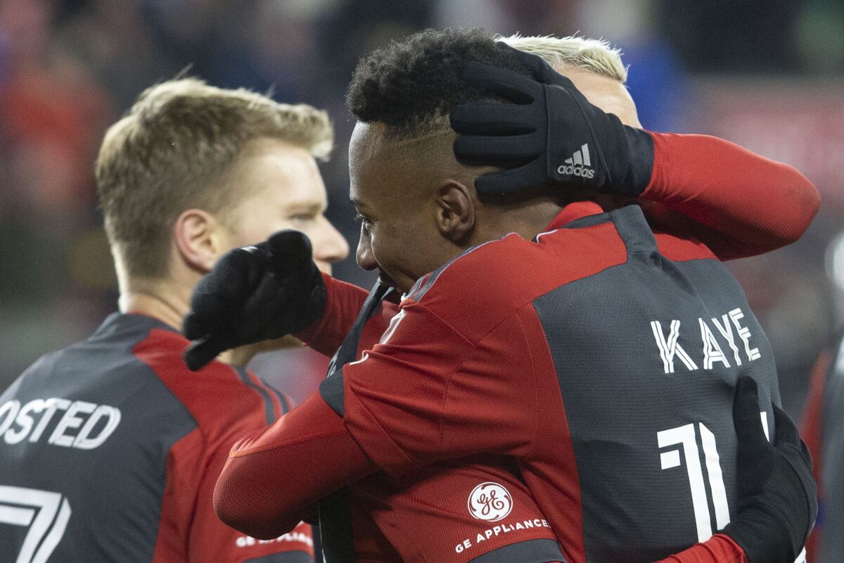 Toronto FC's Mark-Anthony Kaye is congratulated by Federico Bernardeschi after scoring against Inter Miami during the second half of an MLS soccer match in Toronto, Saturday, March 18, 2023. (Chris Young/The Canadian Press via AP)