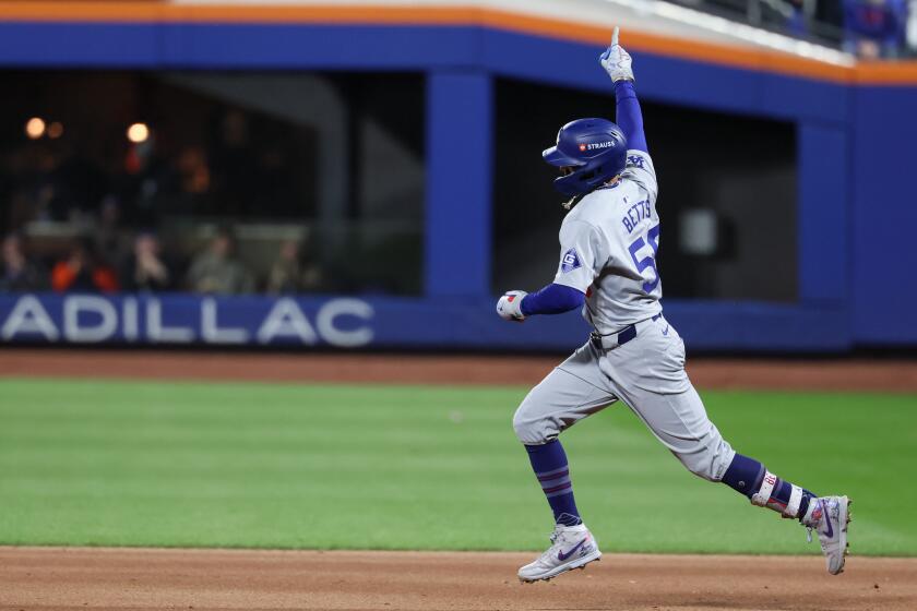 NEW YORK, NEW YORK - OCTOBER 18: Mookie Betts #50 of the Los Angeles Dodgers rounds the bases after a solo home run during the sixth inning in game five of the National League Championship Series against the New York Mets at Citi Field on Friday, Oct. 18, 2024 in New York. (Robert Gauthier / Los Angeles Times)