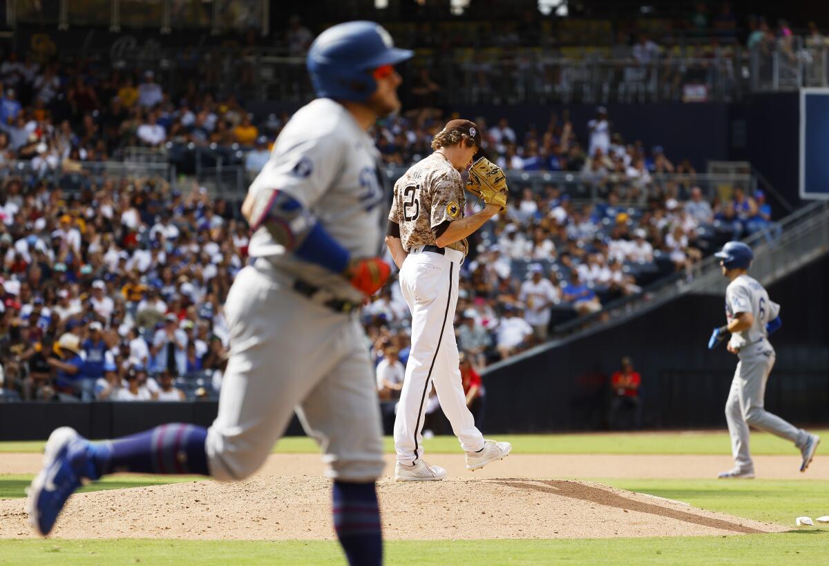 Padres reliever Tim Hill reacts after walking in a run Sunday against the Dodgers at Petco Park.