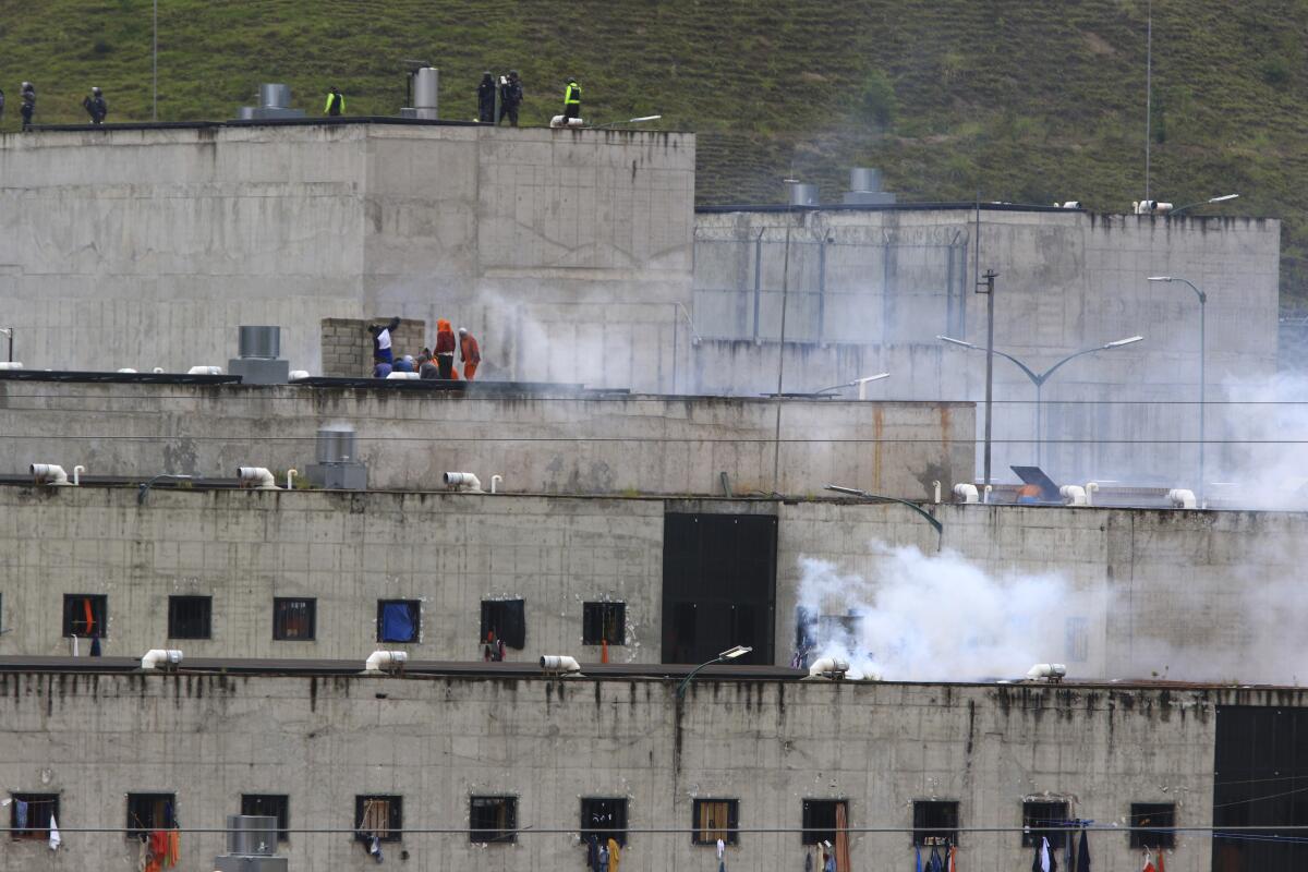 Tear gas rises from parts of Turi prison in Cuenca, Ecuador