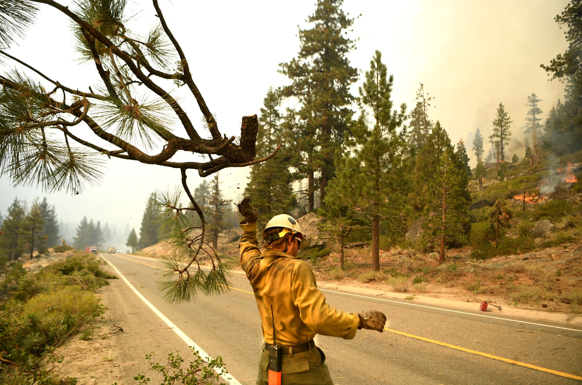 A firefighter on the side of a road