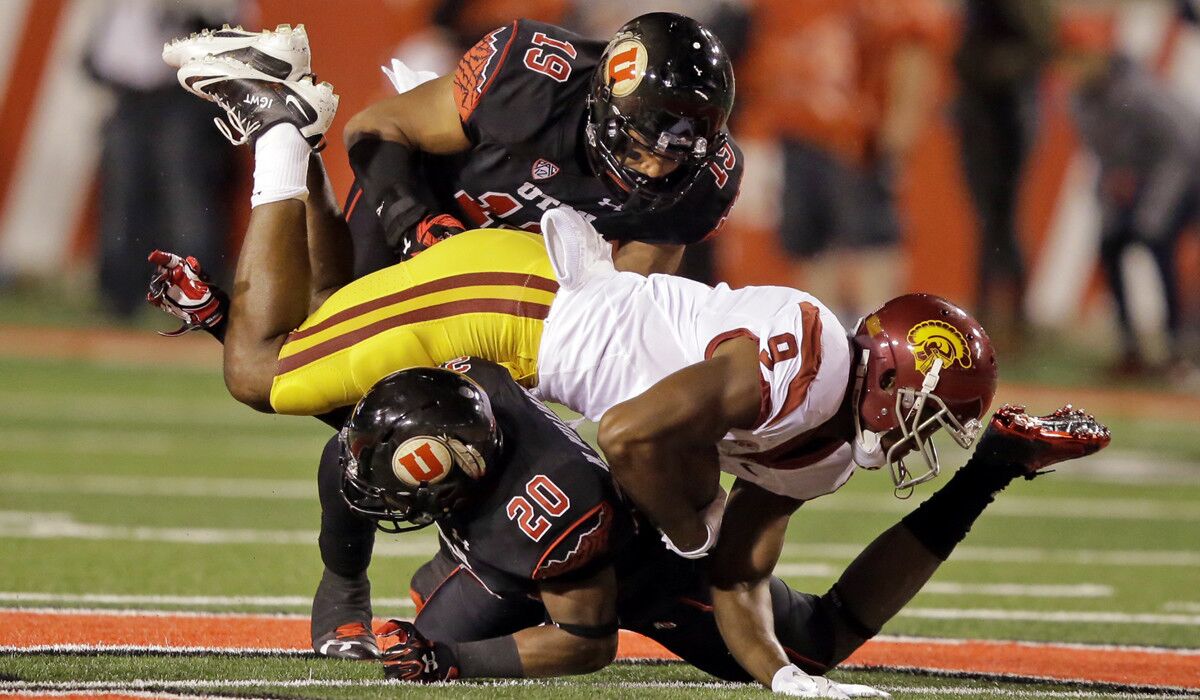 USC wide receiver JuJu Smith-Schuster (9) is tackled by Utah's Marcus Williams (20) and Sunia Tauteoli at Salt Lake City last week.