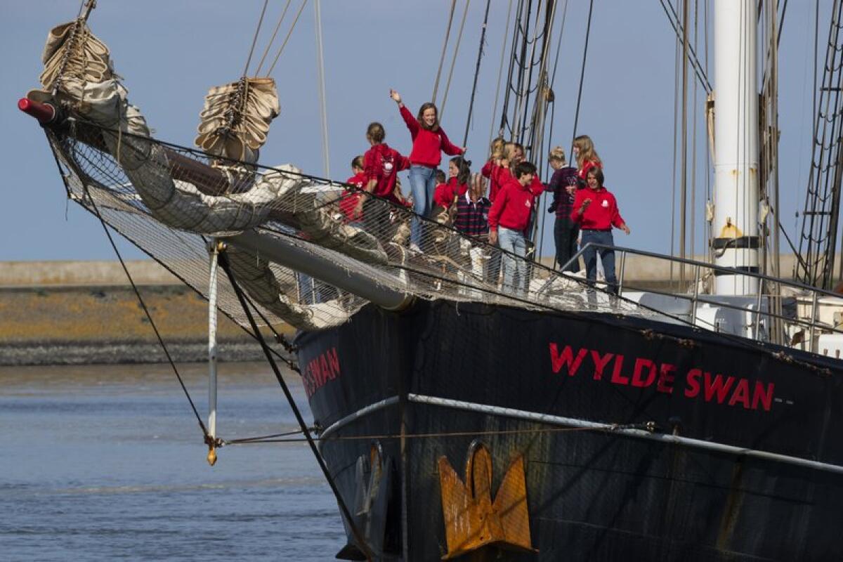 Dutch teenagers aboard the Wylde Swan cheer their arrival in the Netherlands.