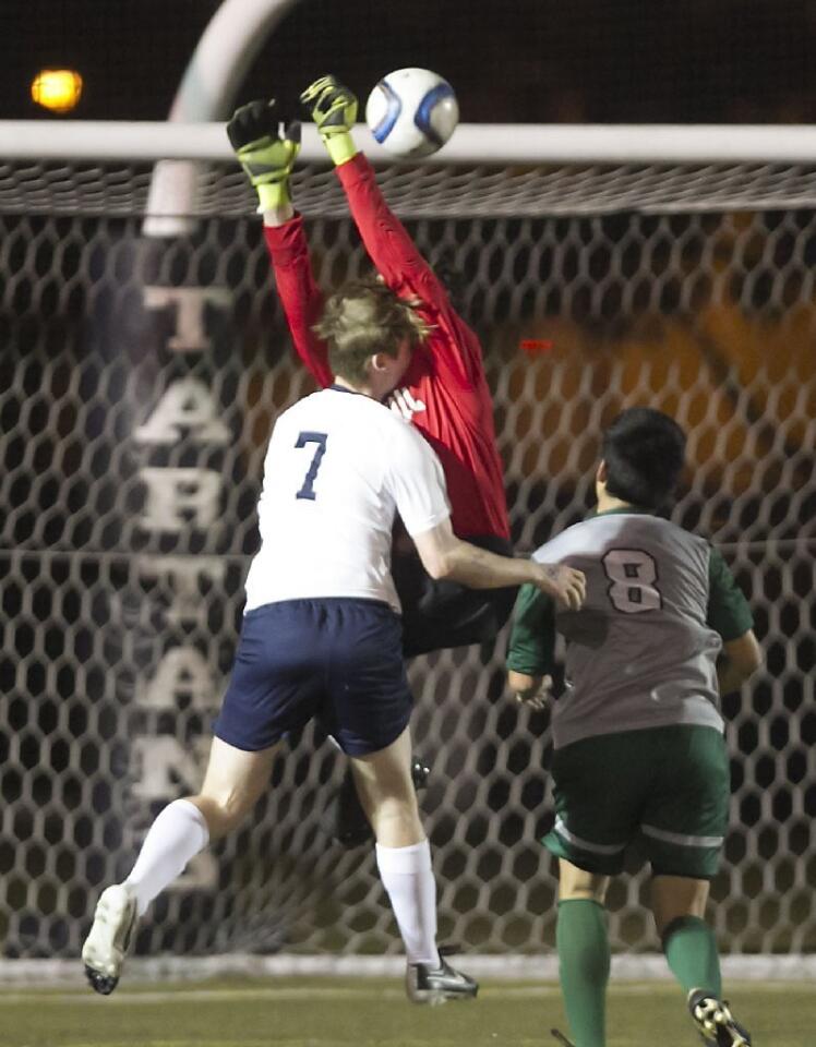 Sage Hill School goalie Chase Rebeil tries to stop a shot by St. Margaret's Peyton Ridland that goes in for a score.