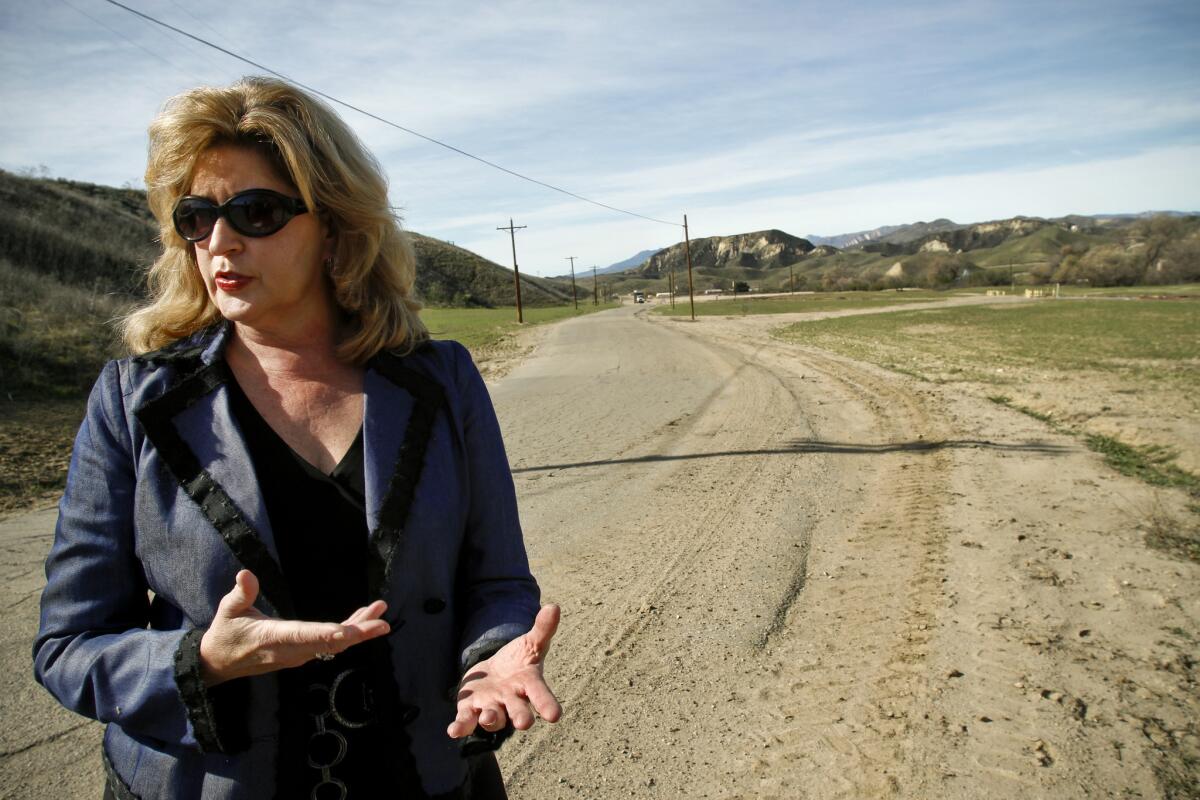 Marlee Lauffer, of Newhall Land, takes a tour of the ranch along the Santa Clara River for which the California Department of Fish and Wildlife issued construction permits that are now being challenged in court.
