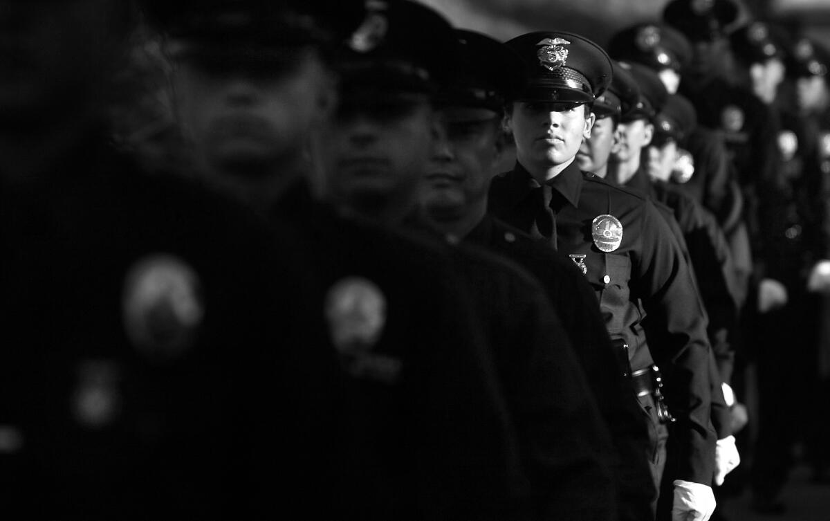 Members of the Los Angeles Police Department recruit class line up for graduation at the LAPD academy in Elysian Park. The class began with 46 recruits, but at the end of their training, only 30 would graduate.
