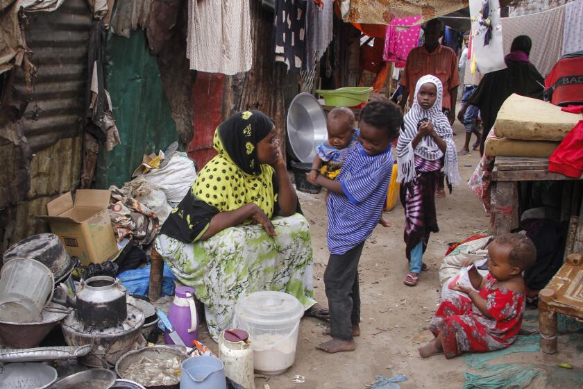 In this photo taken Thursday, March 26, 2020, residents live in crowded conditions in the Sayidka camp for internally displaced people in Mogadishu, Somalia. The country has only a handful of confirmed cases of the new coronavirus so far but residents of the camp, who have already fled drought and violence from the Islamist al-Shabab militant group, say they are fearful of the virus and feel vulnerable. (AP Photo/Farah Abdi Warsameh)