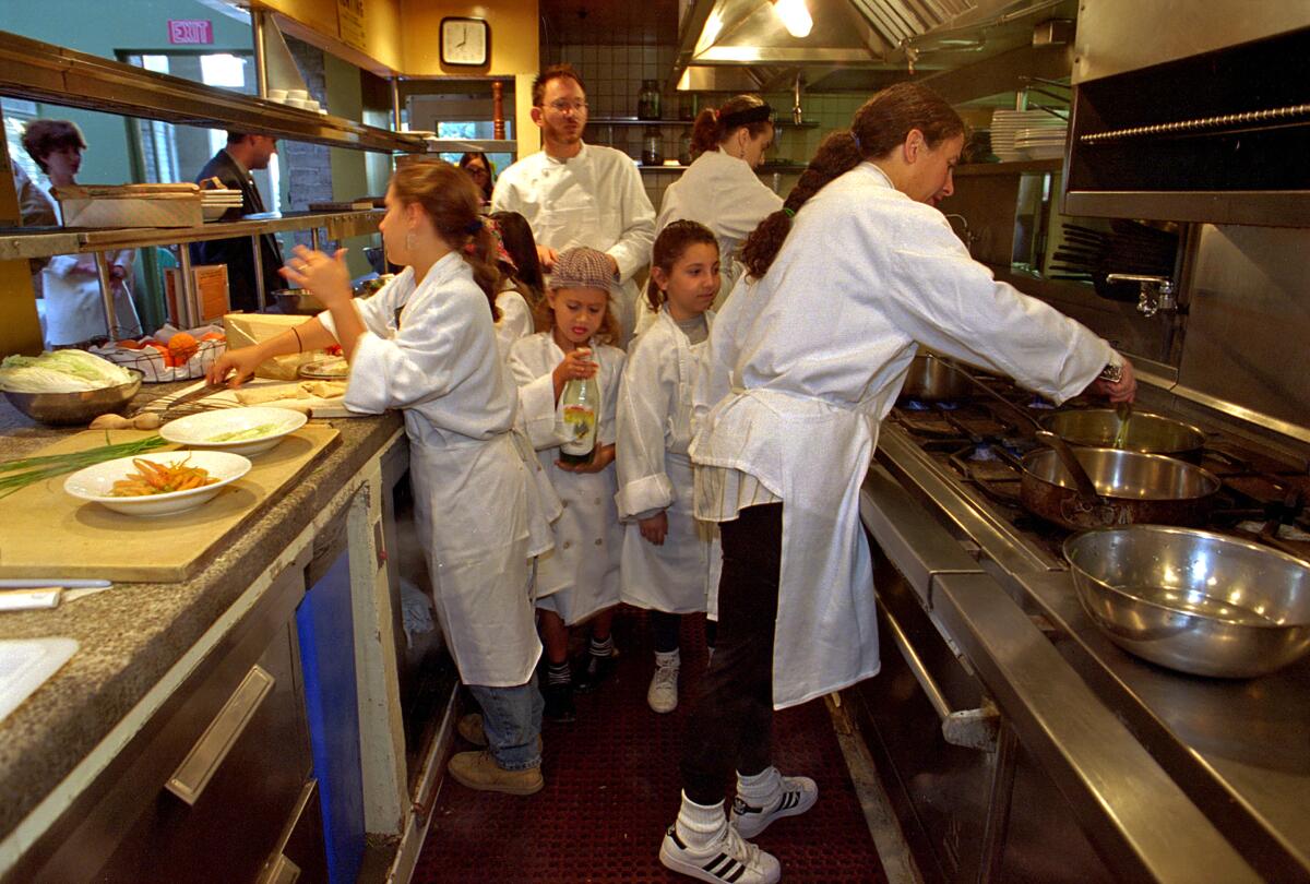 Chefs cook in a restaurant kitchen