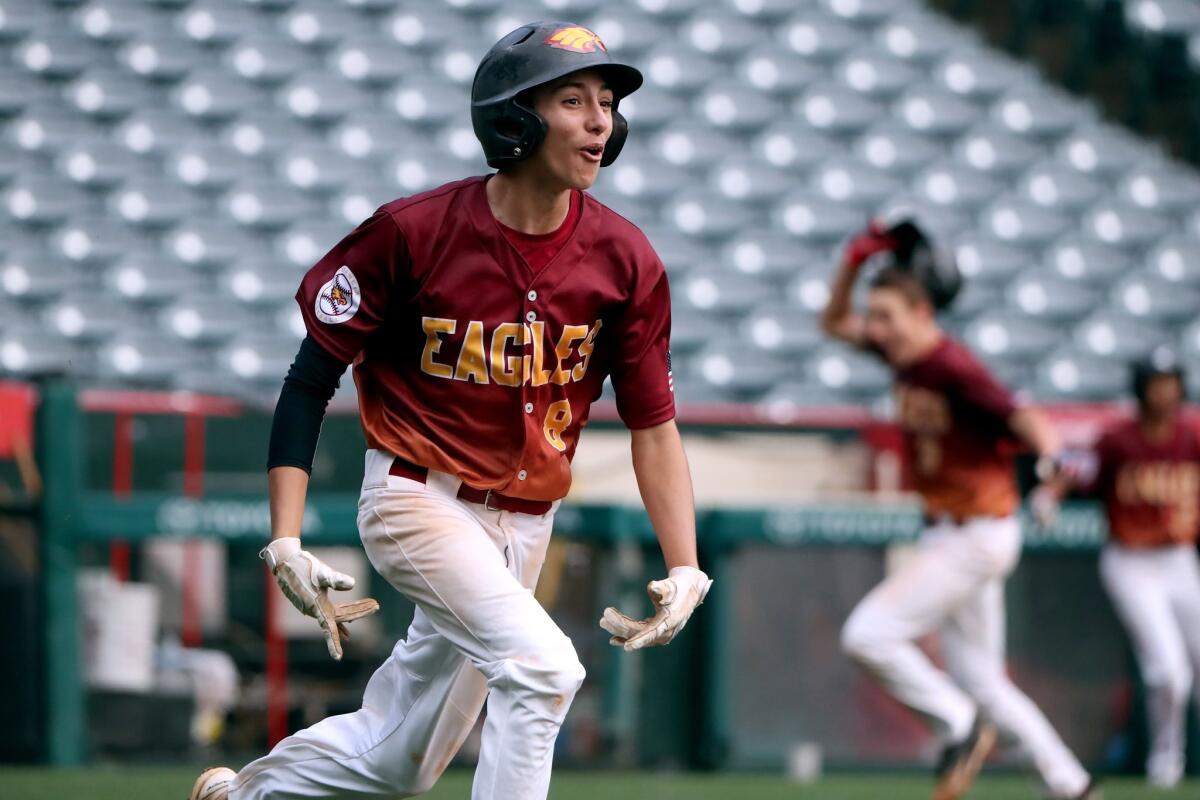 Estancia High's Nick Peralez runs to first base after driving in the game-winning run with a two-out single to right field in the bottom of the seventh inning in the Halo Classic against Costa Mesa at Angel Stadium on Wednesday.