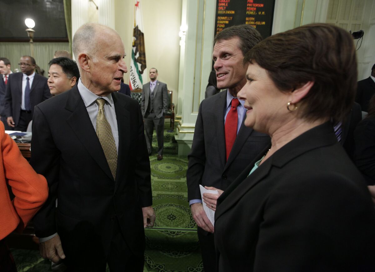 Gov. Jerry Brown, left, receives congratulations on his State of the State address from state Sen. Ted Gaines, R-Rocklin, and his wife, Assemblywoman Beth Gaines, R-Rocklin, at the Capitol last month.