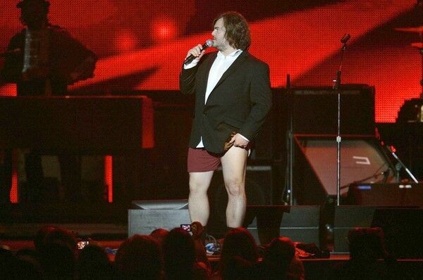 Host Jack Black ponders auctioning off his pants for charity after he auctioned off his shoes and tie during the MusiCares Person of the Year tribute concert to Neil Young at the Los Angeles Convention Center. The Grammy Awards are Sunday night at Staples Center.