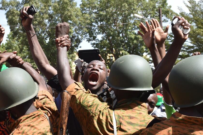 A crowd gathers in front of army headquarters in Burkina Faso's capital, Ouagadougou, demanding that the army take over after the resignation of President Blaise Compaore on Oct. 31.