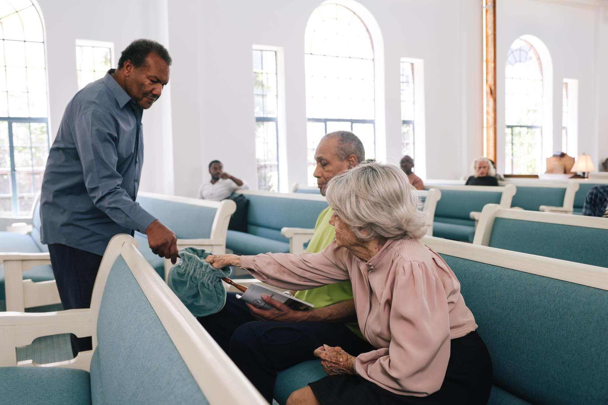 Helen Lechner gives collection money at the Third Church of Christ, Scientist of Los Angeles.