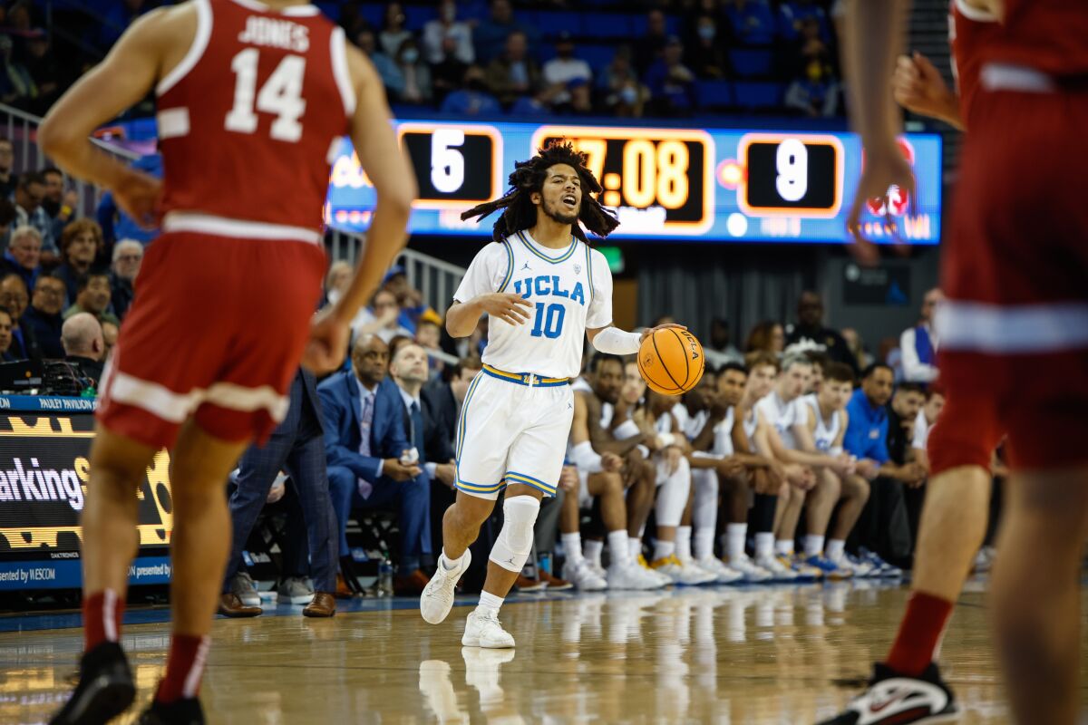 UCLA guard Tyger Campbell drives the ball against a Stanford defender at Pauley Pavilion on Thursday.