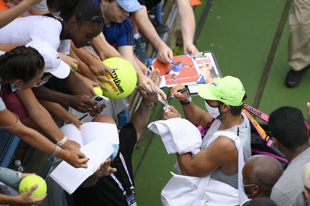 Rafael Nadal, of Spain, signs for fans as he leaves a practice session at the Citi Open tennis tournament, Saturday, July 31, 2021, in Washington. (AP Photo/Nick Wass)