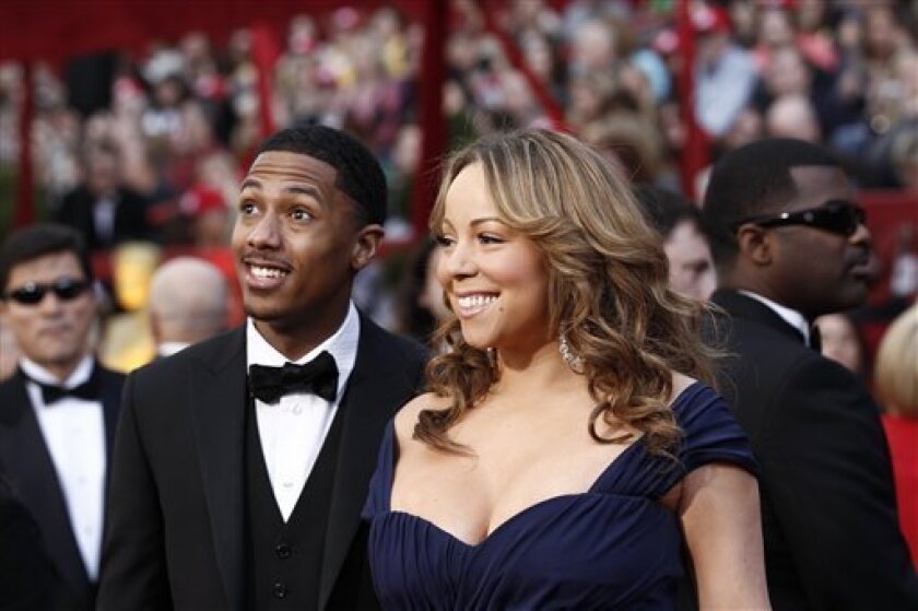 FILE - In a March 7, 2010 file photo, Mariah Carey and Nick Cannon arrives at the 82nd Academy Awards, in the Hollywood section of Los Angeles. Carey gave birth to twins, a baby girl and boy, Saturday morning April 30, 2011 at an undisclosed hospital in Los Angeles. Carey's representative, Cindi Berger, confirmed the births to The Associated Press. (AP Photo/Matt Sayles, File)