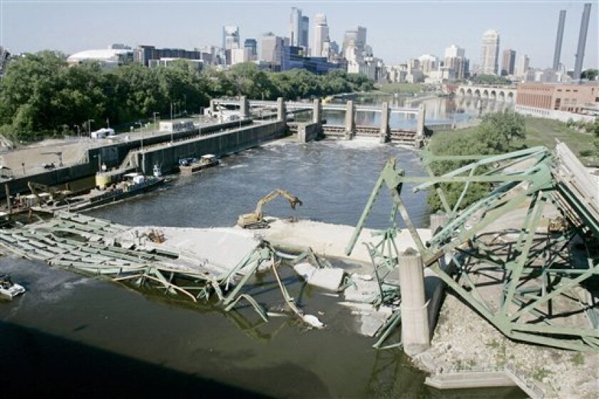 In this Aug. 31, 2007 file photo, the Minneapolis skyline is shown in the distance in this view of the Interstate 35W bridge which collapsed into the Mississippi River, Aug. 1, into the Mississippi River in Minneapolis. Transportation safety officials are set to issue a final ruling this week on the cause of the deadly Minneapolis bridge collapse that killed 13 people and injured 145. (AP Photo/Jim Mone,file)