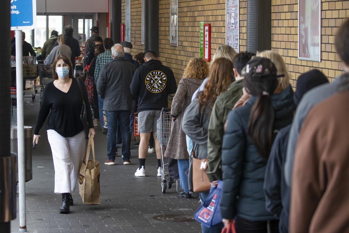 Shoppers lining up outside a supermarket