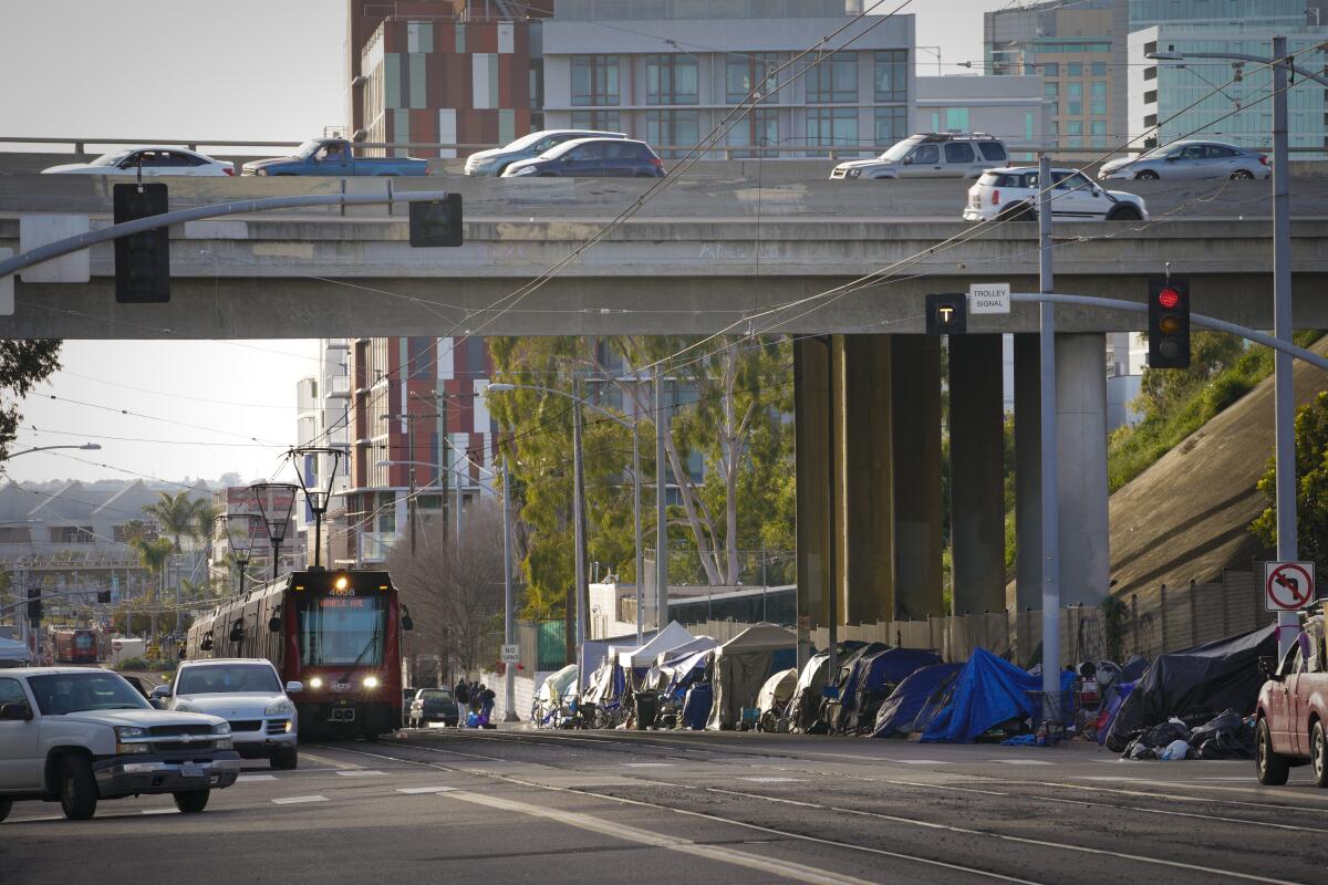 Homeless encampments line the sidewalk along Commercial Street in downtown on Thursday, February 16, 2023.