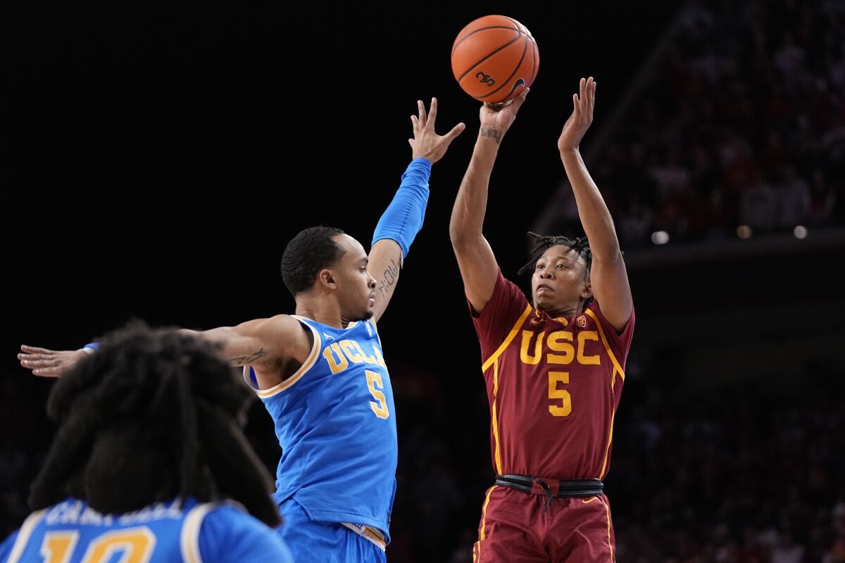 USC guard Boogie Ellis shoots over UCLA guard Amari Bailey during the second half of the Trojans' 77-64 win.