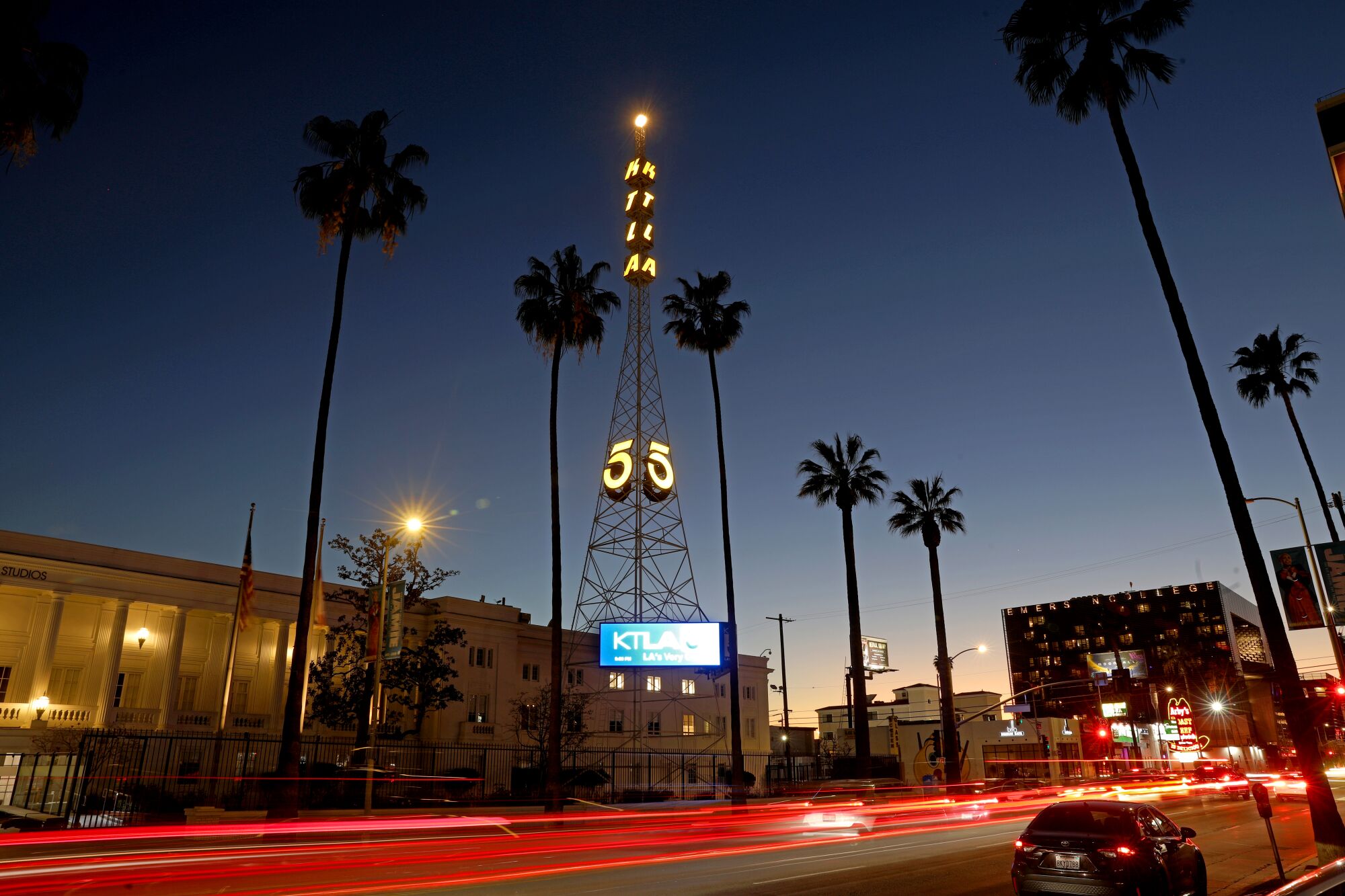 The KTLA-TV Channel 5 transmission tower in Hollywood, with cars zooming by as streaks of red light.