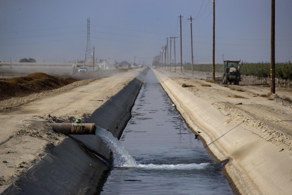 Water is pumped into a canal on a ranch in the Central Valley. 