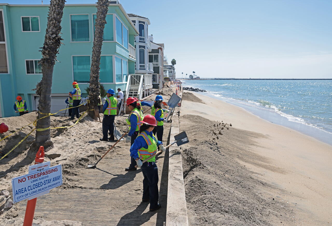 Crews shovel sand on the Long Beach Peninsula after the storm damaged parts of the boardwalk on Sept. 11.