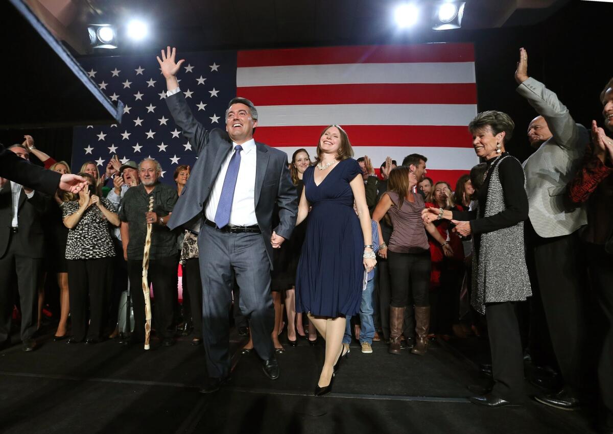 U.S. Rep. Cory Gardner and wife Jaime wave to supporters during a GOP election night gathering in Denver.