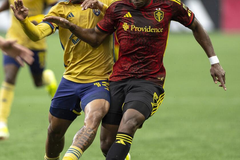 Seattle Sounders defender Nouhou Tolo dribbles the ball upfield as Real Salt Lake midfielder Nelson Palacio goes for the ball during the first half of an MLS soccer match Wednesday, May 29, 2024, in Seattle. (Nick Wagner/The Seattle Times via AP)