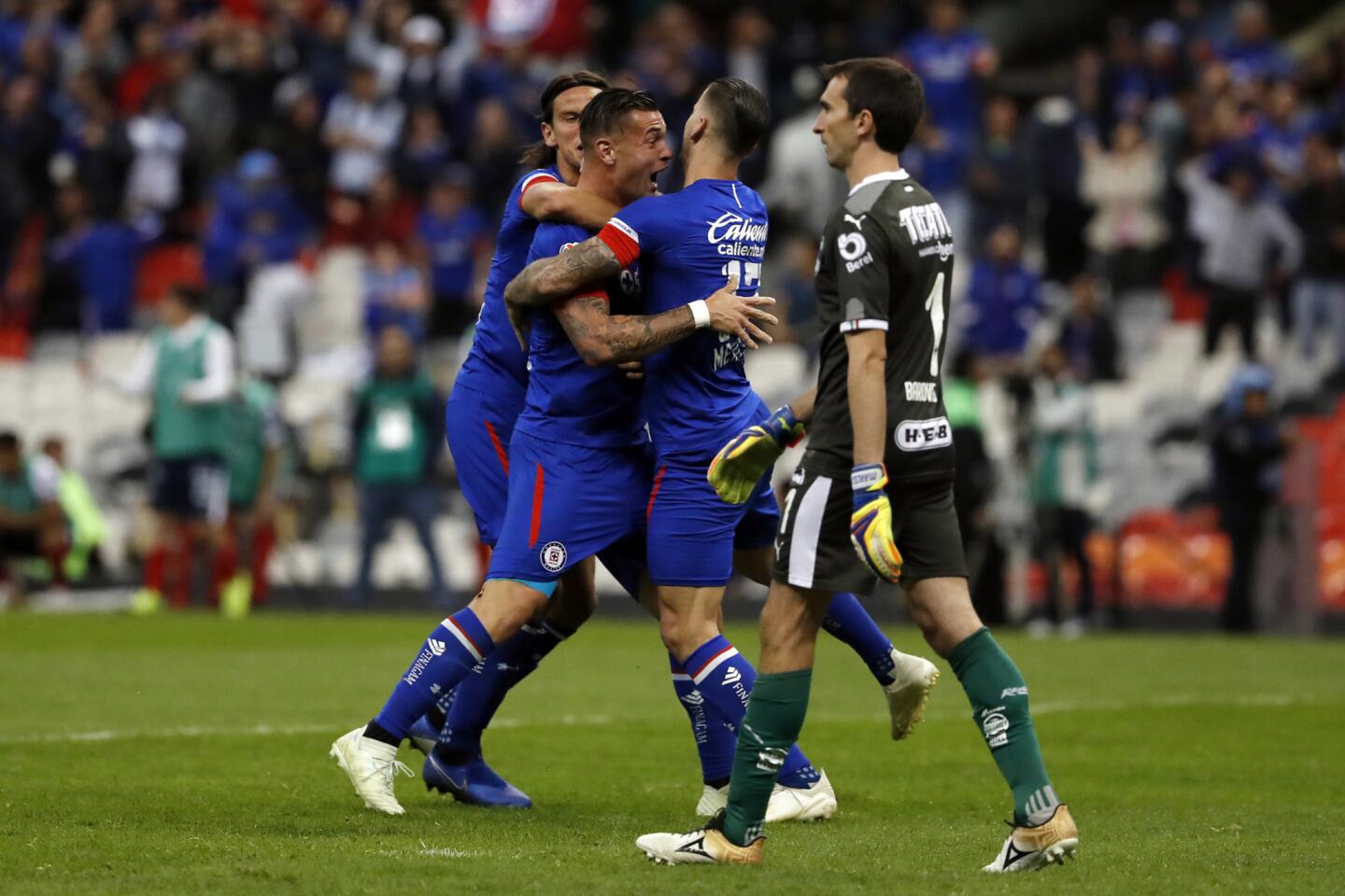 Cruz Azul players celebrate a goal scored by Milton Caraglio, second from left, against Monterrey during a Mexico soccer league second leg semifinals match against Monterrey at Azteca stadium in Mexico City, Saturday, Dec. 8, 2018. (AP Photo/Moises Castillo)