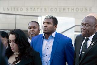 LOS ANGELES, CA - February 11, 2023: Former Dodgers outfielder Yasiel Puig, center, at a news conference outside the federal courthouse in downtown Los Angeles on Saturday February 11, 2023 in Los Angeles, CA. (Brian van der Brug / Los Angeles Times)