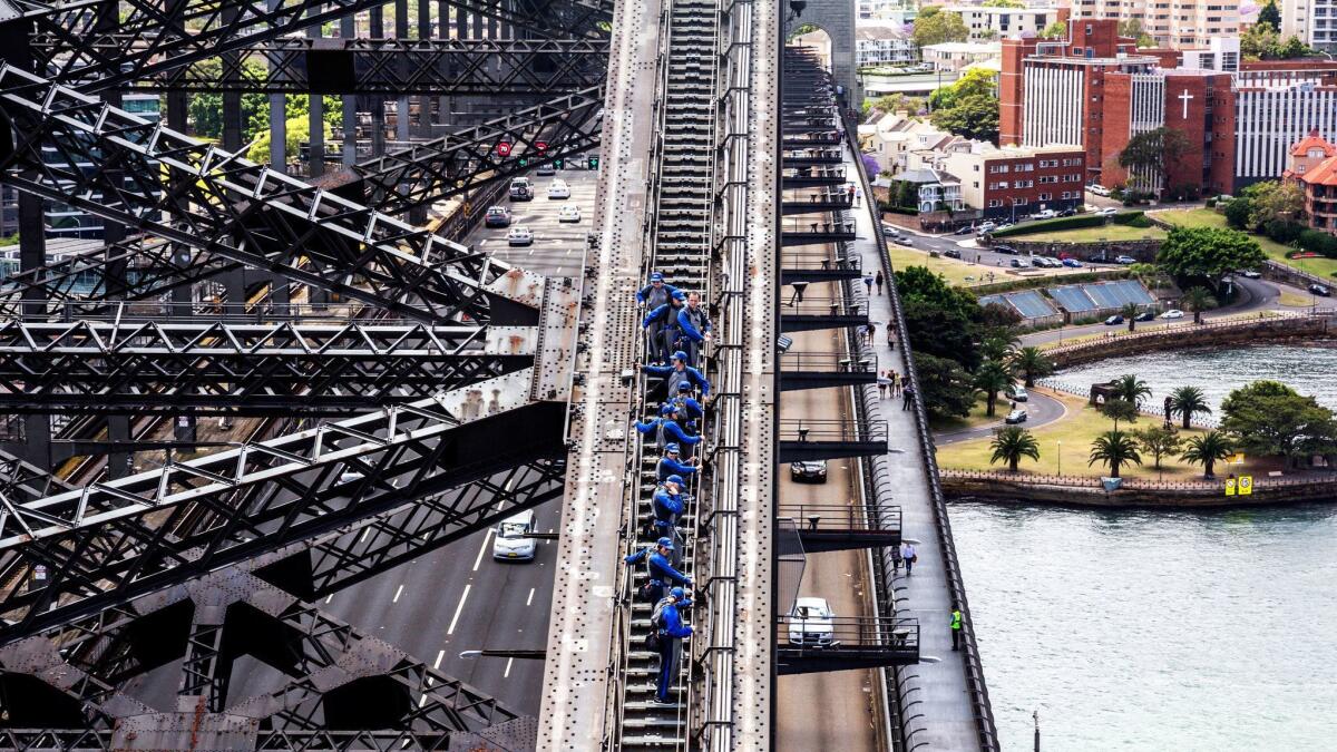Small groups of people doing the Sydney Harbour Bridge Climb.