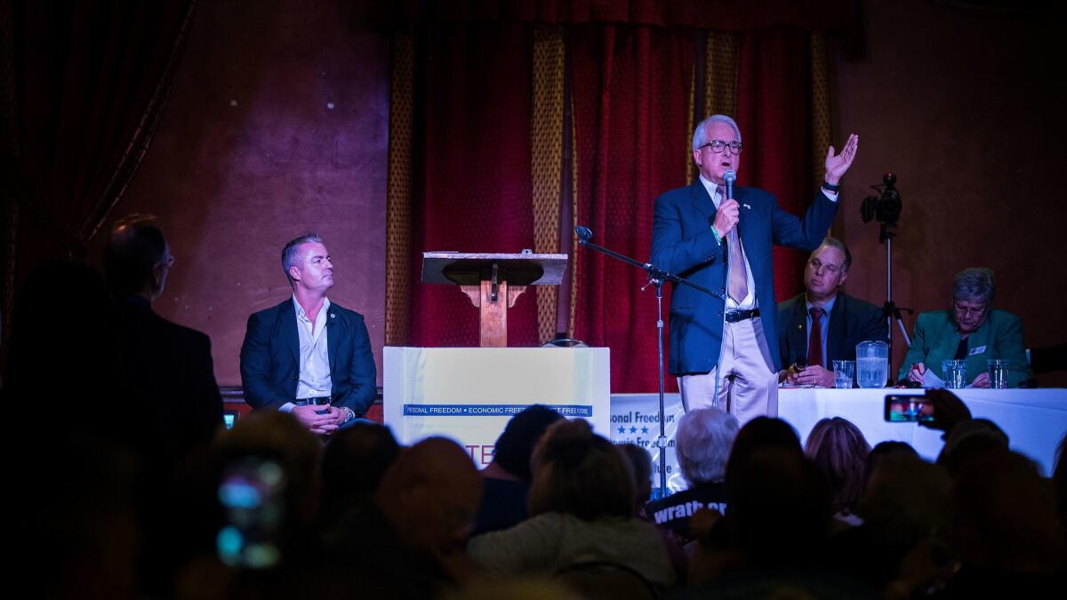 Republican candidate for governor John Cox, right, answers a question as his GOP opponent Travis Allen, left, listens during a debate hosted by the Redlands Tea Party Patriots at the Mill Creek Cattle Co. in Mentone.