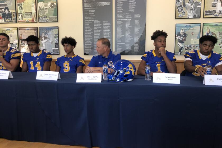 Bishop Amat players and coaches answer questions at media day.