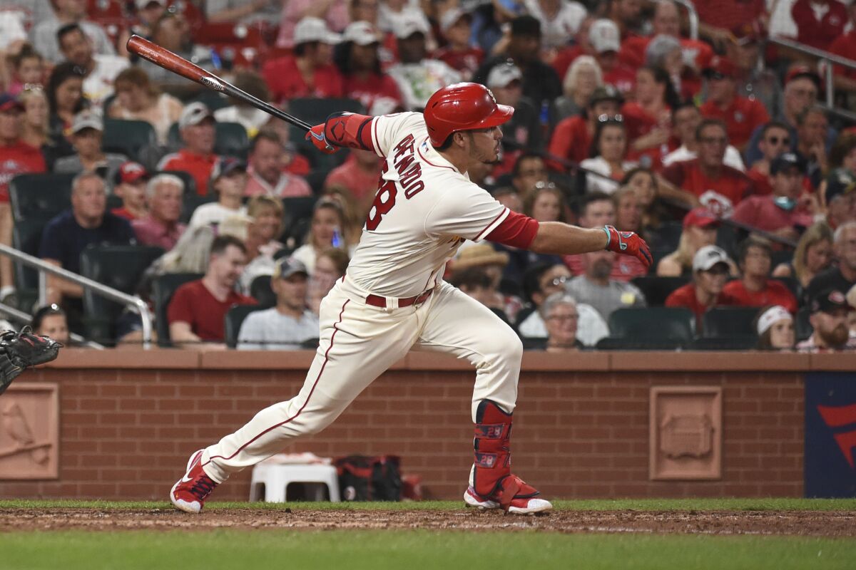 St. Louis Cardinals' Nolan Arenado watches his RBI-triple during the sixth inning of a baseball game against the Cincinnati Reds on Saturday, Sept. 11, 2021, in St. Louis. (AP Photo/Joe Puetz)