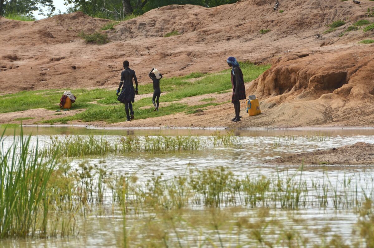 FILE - Children in the town of Terekeka, South Sudan, draw water, Oct. 4, 2017, from a stagnant pond 