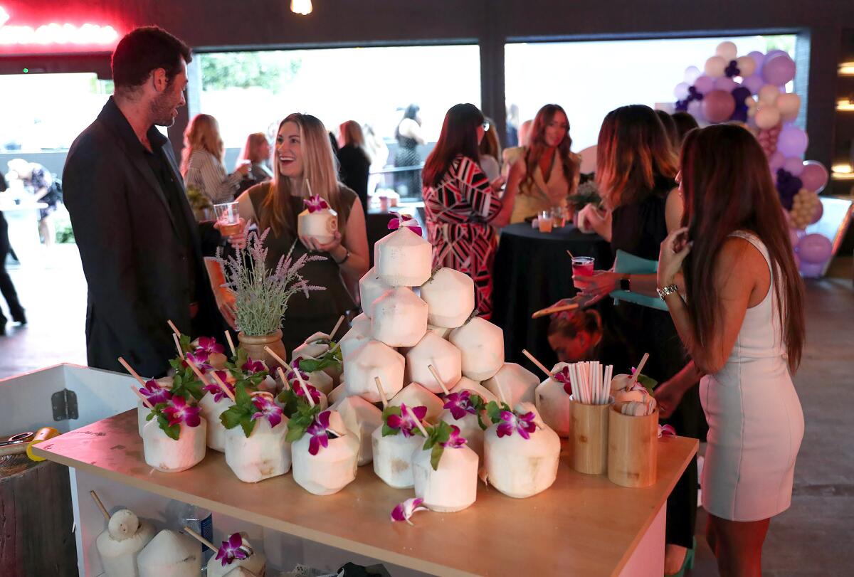 Coconut drinks were a hit at the charity event at the Oppenheim Group office.