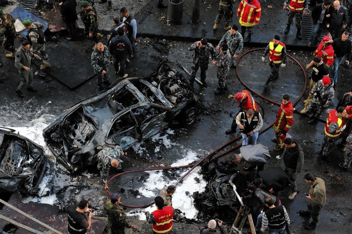 Lebanese security forces and firefighters examine the scene of the explosion that rocked central Beirut on Friday, killing prominent political figure Mohamad Chatah and at least five others.
