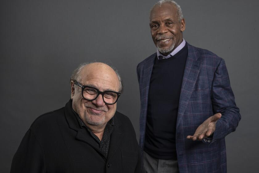 LOS ANGELES, CALIF. -- MONDAY, DECEMBER 9, 2019: Jumanji: The Next Level co-stars Danny DeVito, left, and Danny Glover, right, sit for portraits at the Four Seasons Hotel Los Angeles At Beverly Hills in Los Angeles, Calif., on Dec. 9, 2019. (Brian van der Brug / Los Angeles Times)