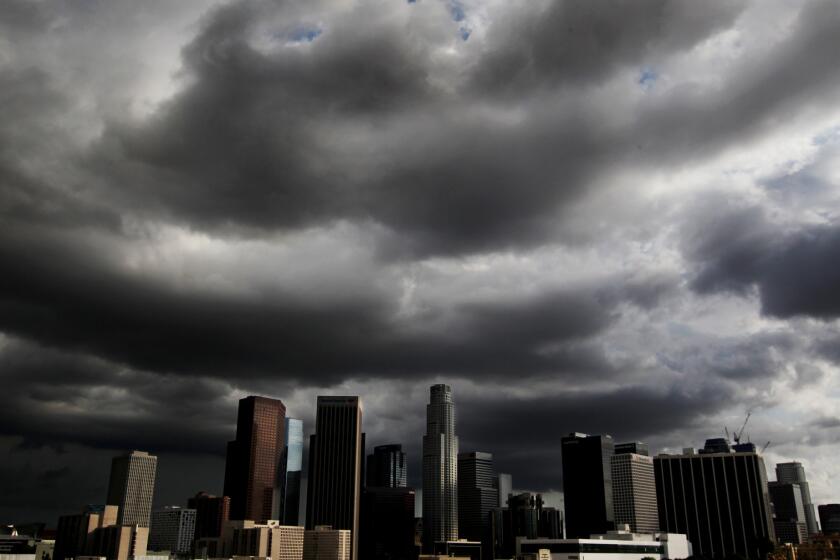 Storm clouds drift over downtown Los Angeles.