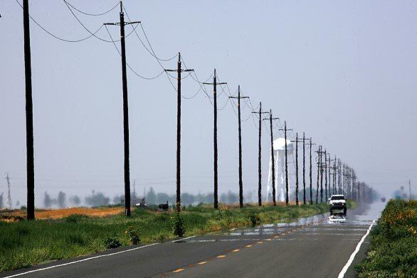 Heat shimmers off the surface of Highway 33 near the agricultural town of Firebaugh, west of Fresno. The state route is a workaday road, a highway for short-haul truckers and agricultural sales reps, for vans shuttling prisoners, convoys of harvesters and even the occasional lone tractor.