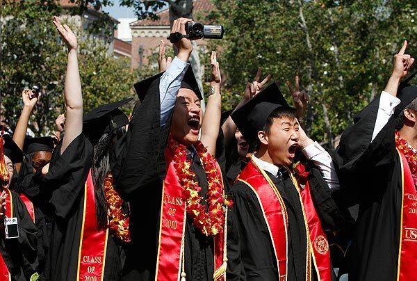 USC graduates let out celebratory whoops before receiving their diplomas at commencement exercises Friday at Alumni Park on campus.